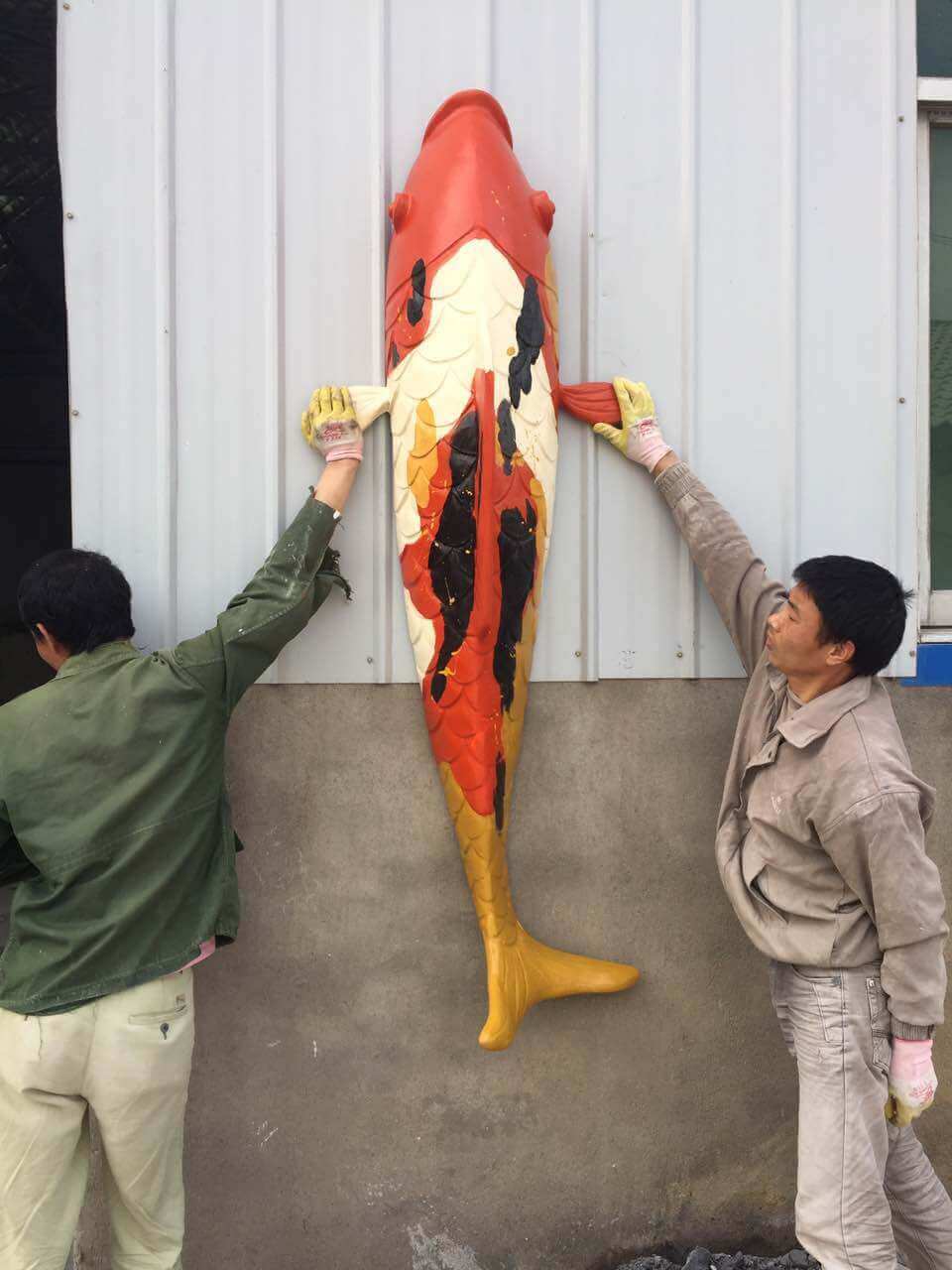 Decorative plaque featuring koi fish in the style of Chinese ink painting